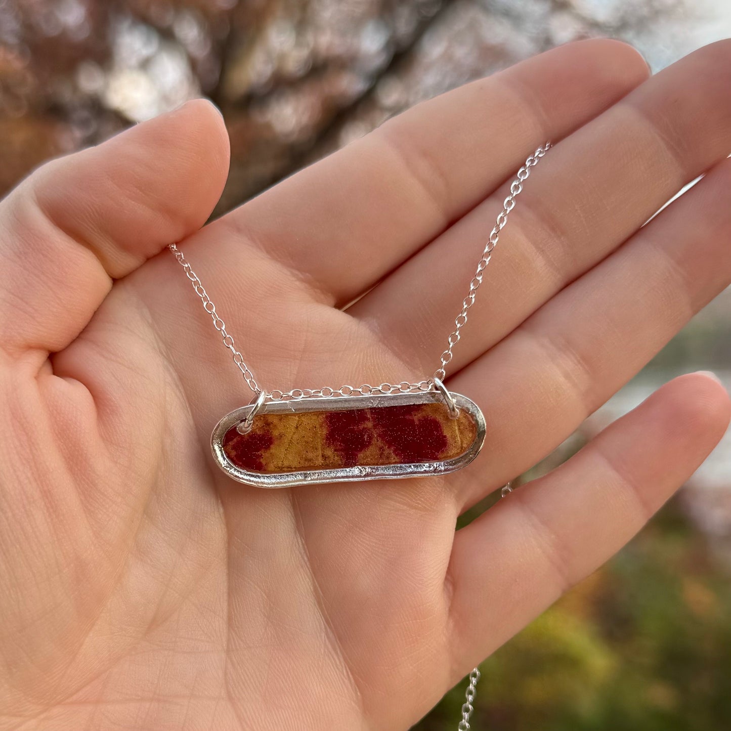 Necklace with real fall leaf preserved in resin and framed in silver bezel
