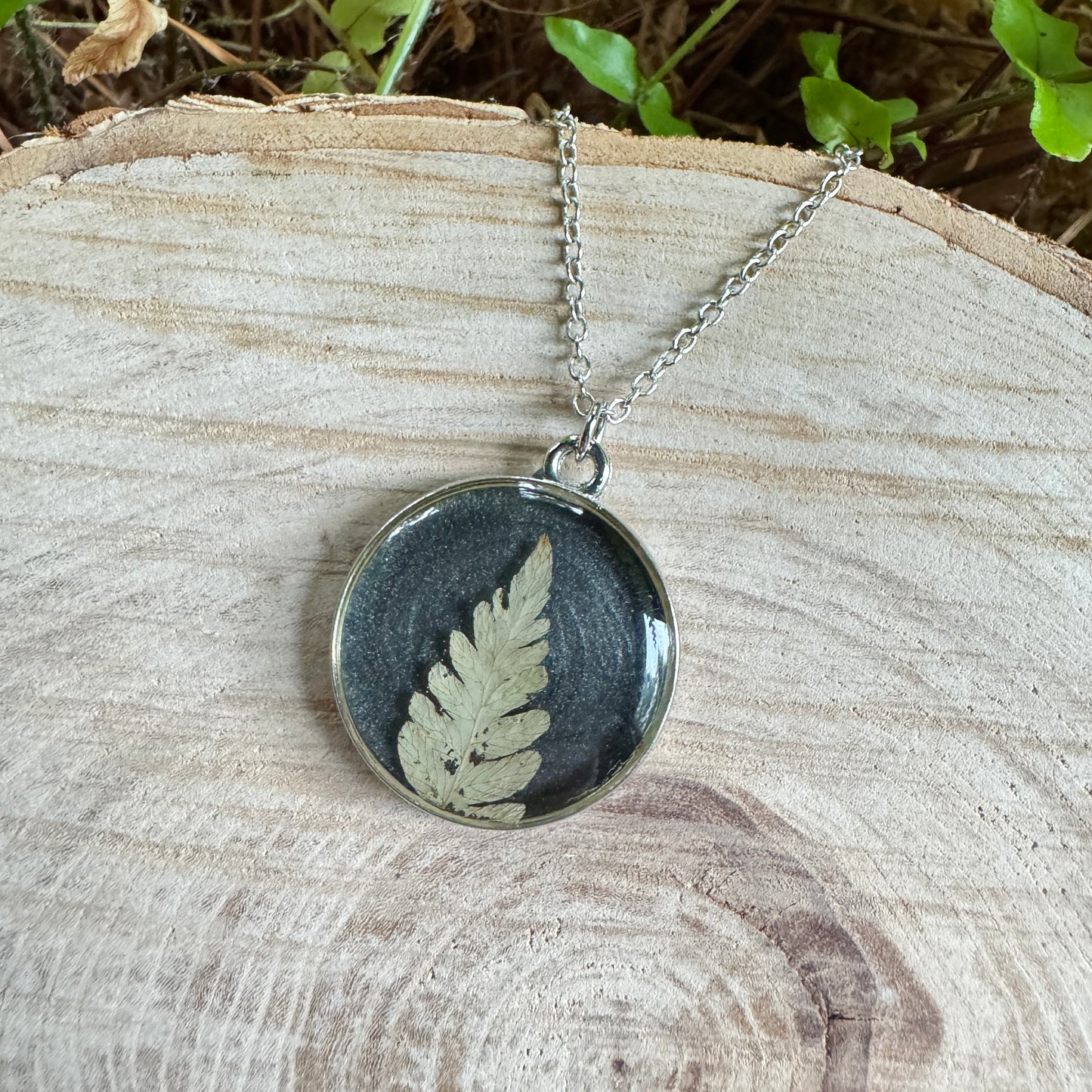 Necklace with real fern frond preserved in resin and silver bezel