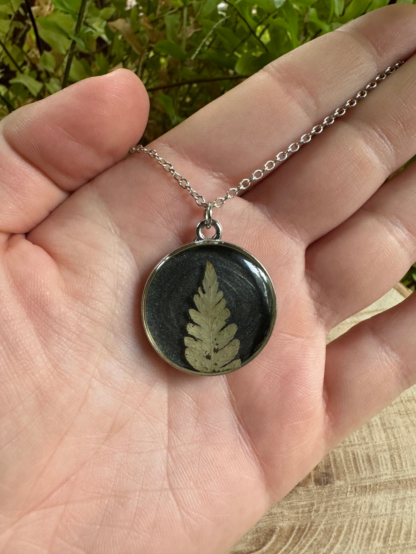 Necklace with real fern frond preserved in resin and silver bezel