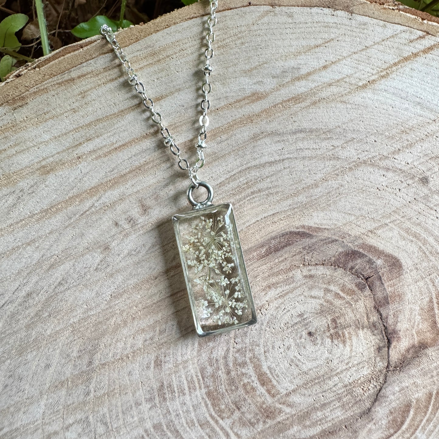 Queen Anne’s Lace necklace with real pressed flower in resin and silver bezel