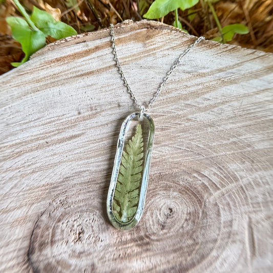Necklace with real fern frond preserved in resin and silver bezel