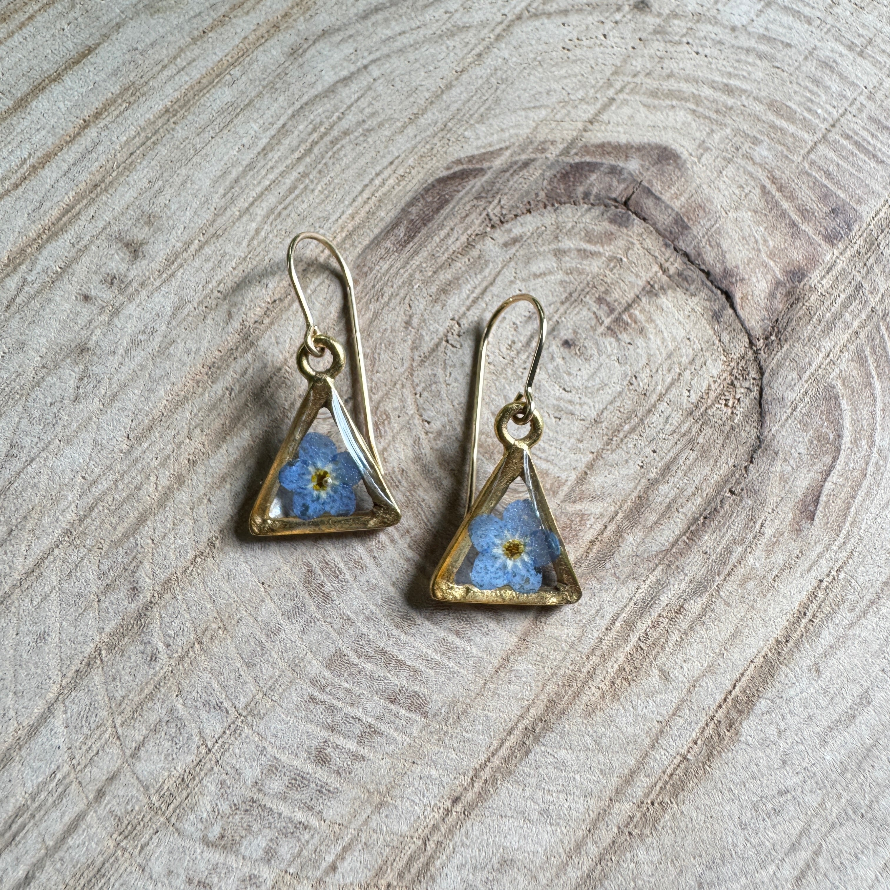 Earrings with real forget-me-not flowers preserved in resin and set in gold filled bezels