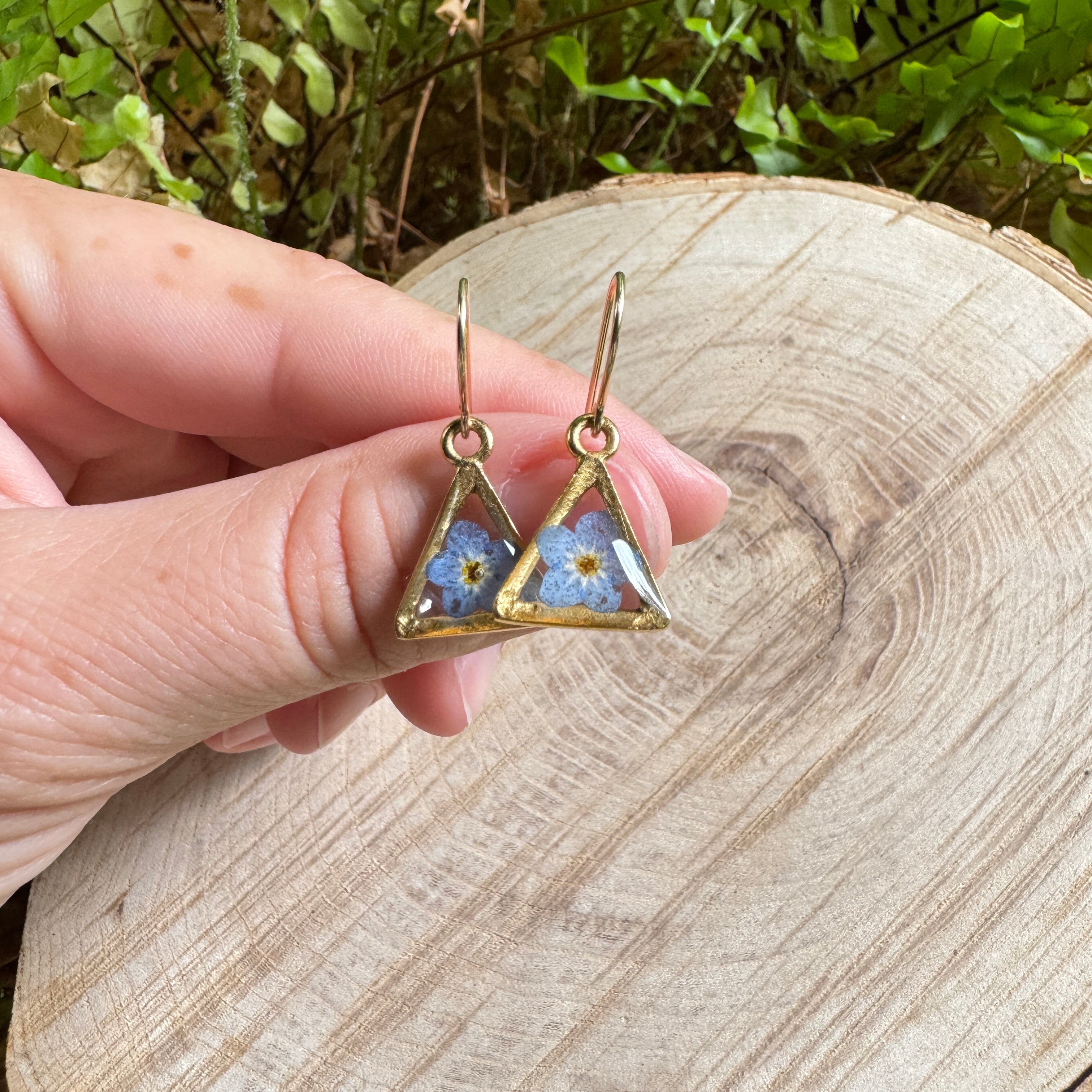Earrings with real forget-me-not flowers preserved in resin and set in gold filled bezels