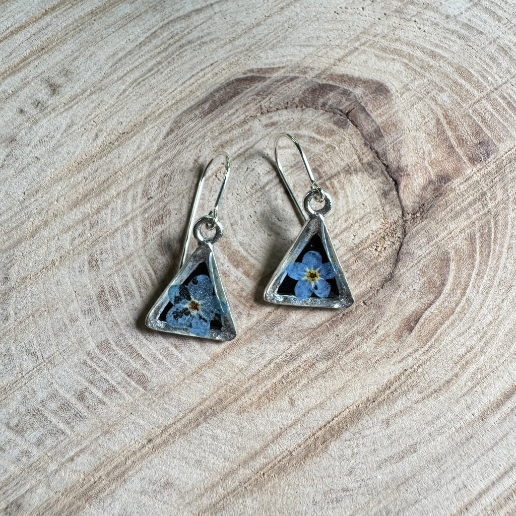 Earrings with real forget-me-not flowers preserved in resin and set in silver bezels