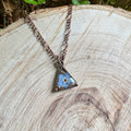 Forget-me-not flower preserved in resin and set in a copper pendant necklace