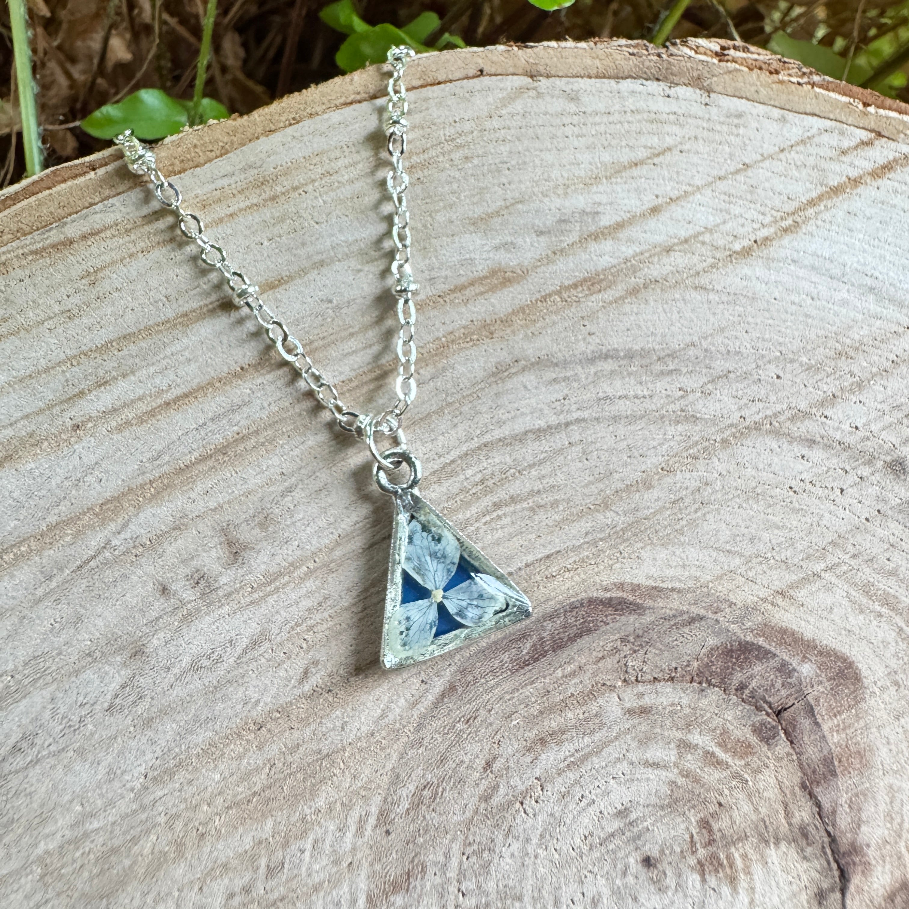 Hydrangea flower necklace preserved in resin with silver bezel