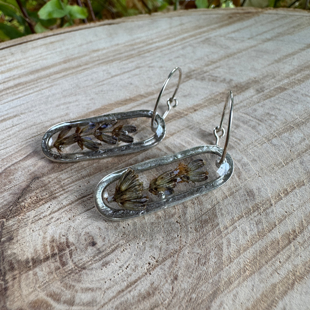 Handmade real lavender oval earrings featuring preserved lavender in resin with sterling silver ear wires.