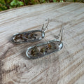 Handmade real lavender oval earrings featuring preserved lavender in resin with sterling silver ear wires.
