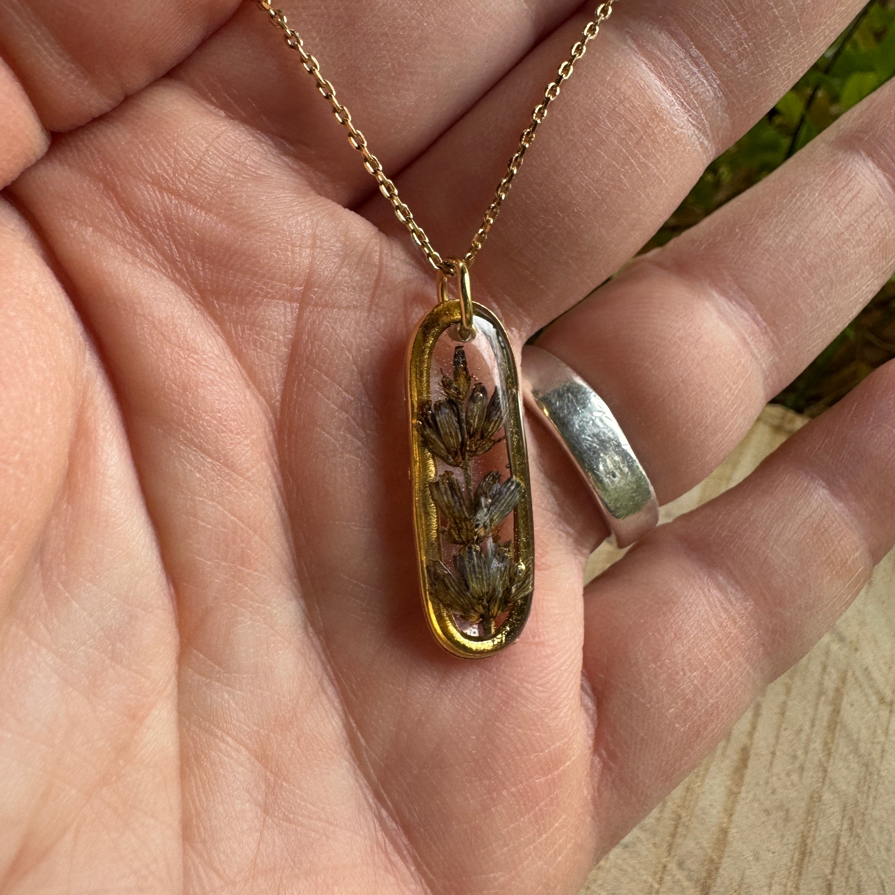 Handmade real lavender oval necklace featuring preserved lavender in resin with First Light clear background, available in gold filled.