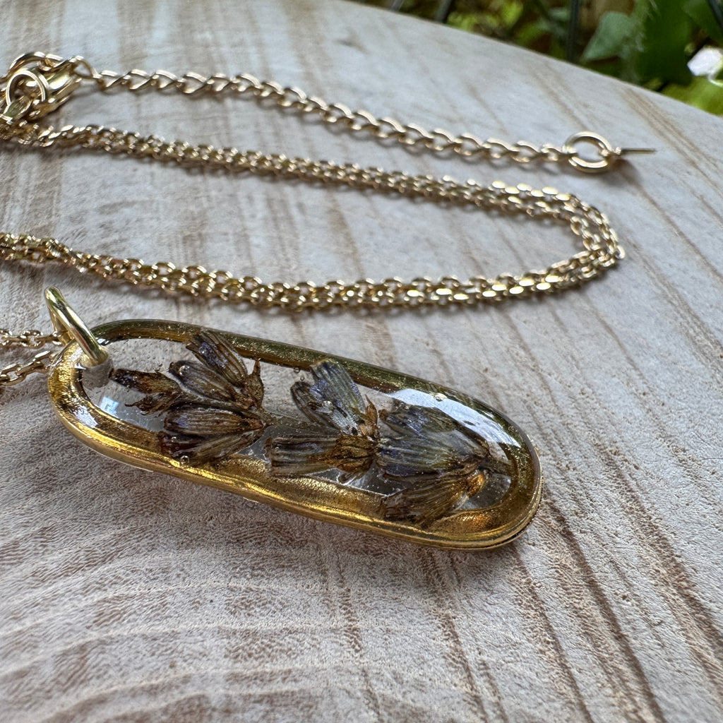 Handmade real lavender oval necklace featuring preserved lavender in resin with First Light clear background, available in gold filled.