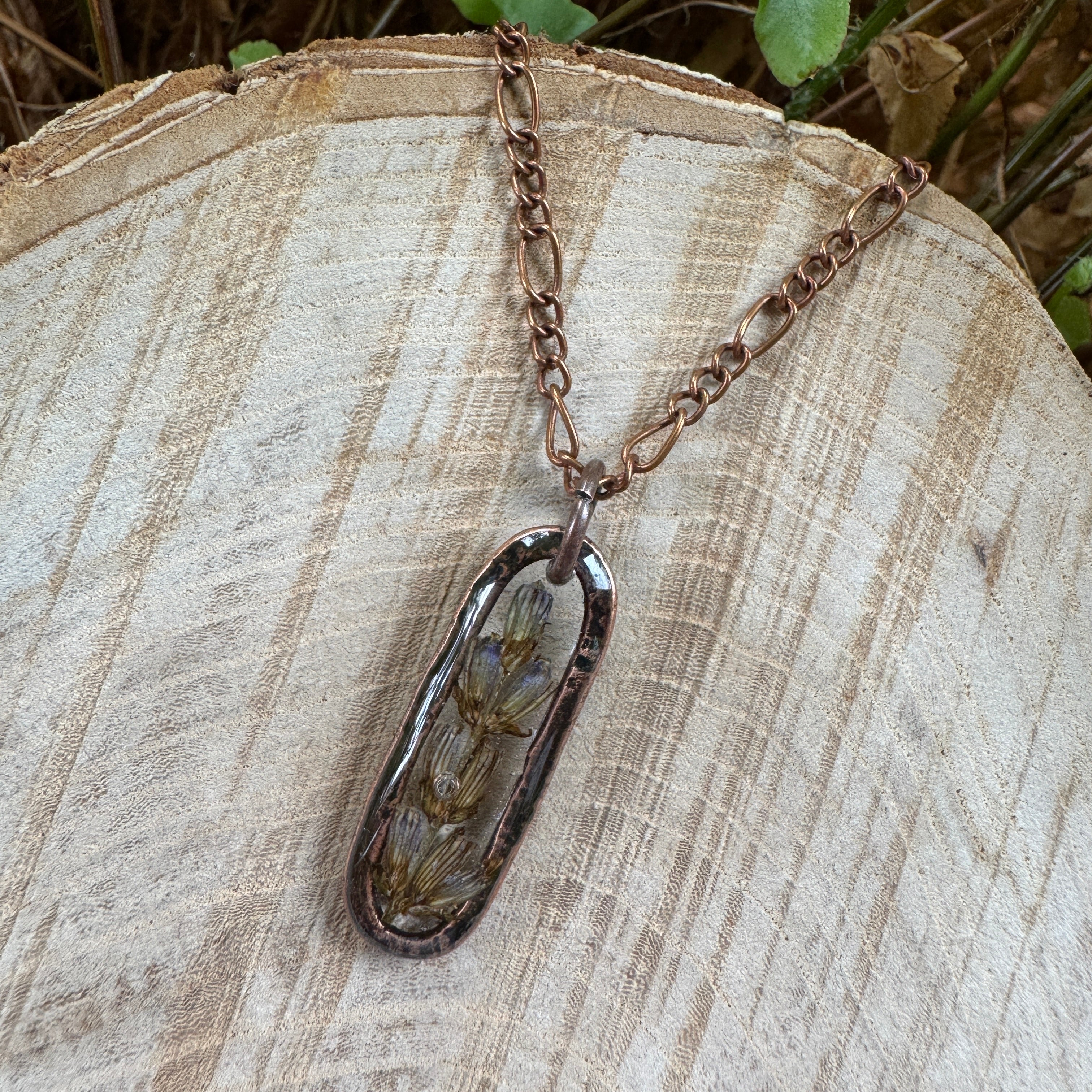 Handmade real lavender oval necklace featuring preserved lavender in resin with First Light clear background, available in antique copper.
