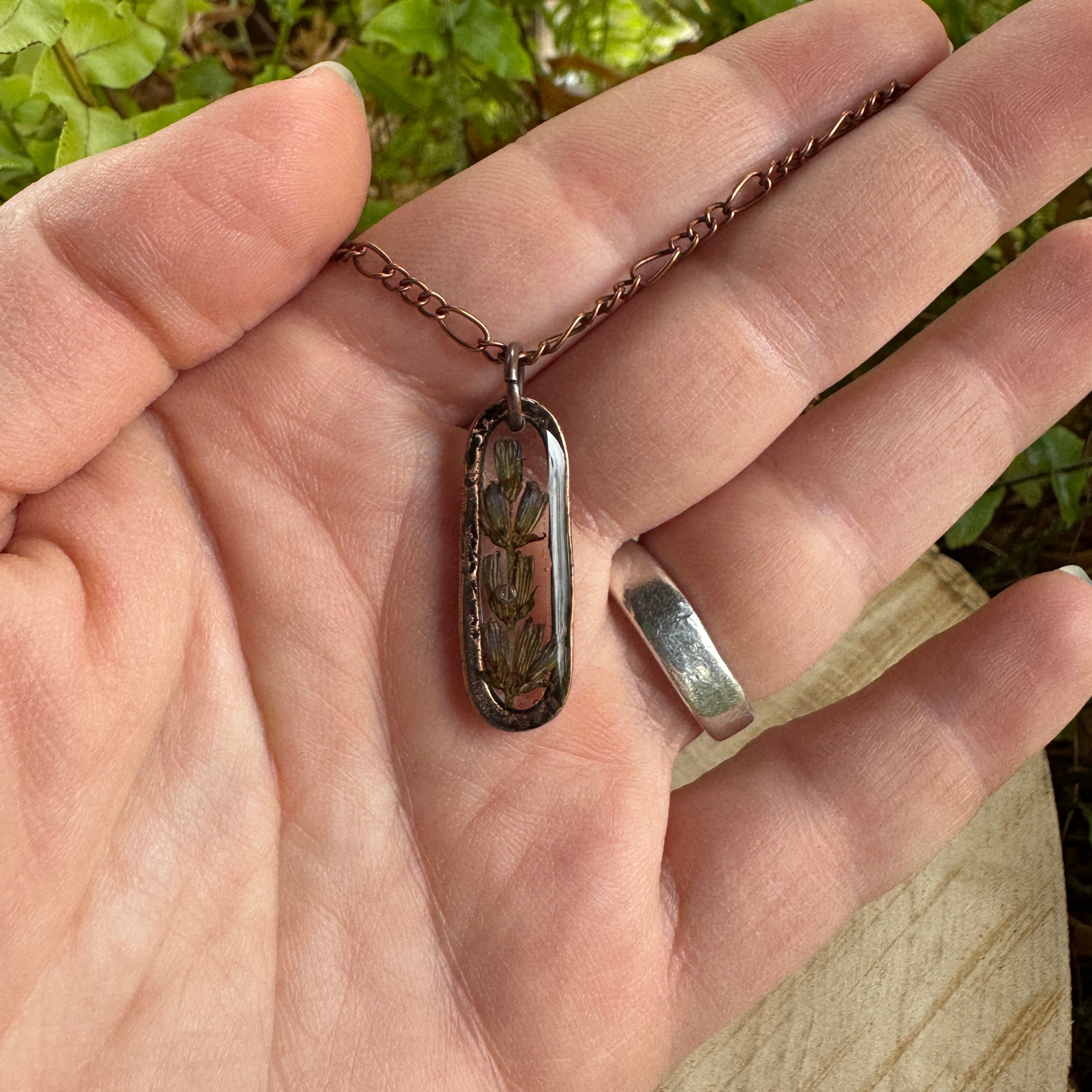 Handmade real lavender oval necklace featuring preserved lavender in resin with First Light clear background, available in antique copper.