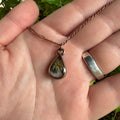 Handmade real lavender teardrop necklace featuring preserved lavender in resin with Morning Mist white background, available in antique copper.