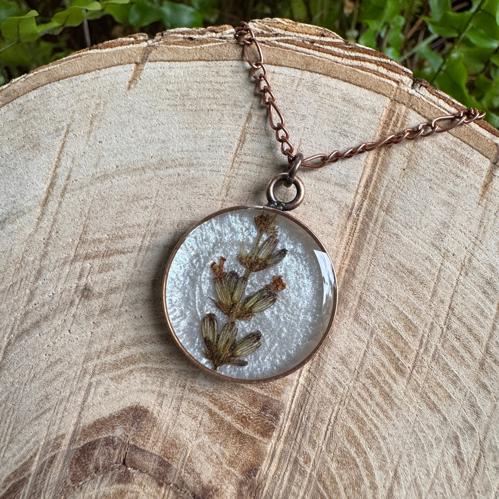 Handmade real lavender circle necklace with preserved lavender in resin, available in Morning Mist white background in antique copper.