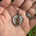 Handmade real lavender circle necklace with preserved lavender in resin, available in Morning Mist white background in antique copper.