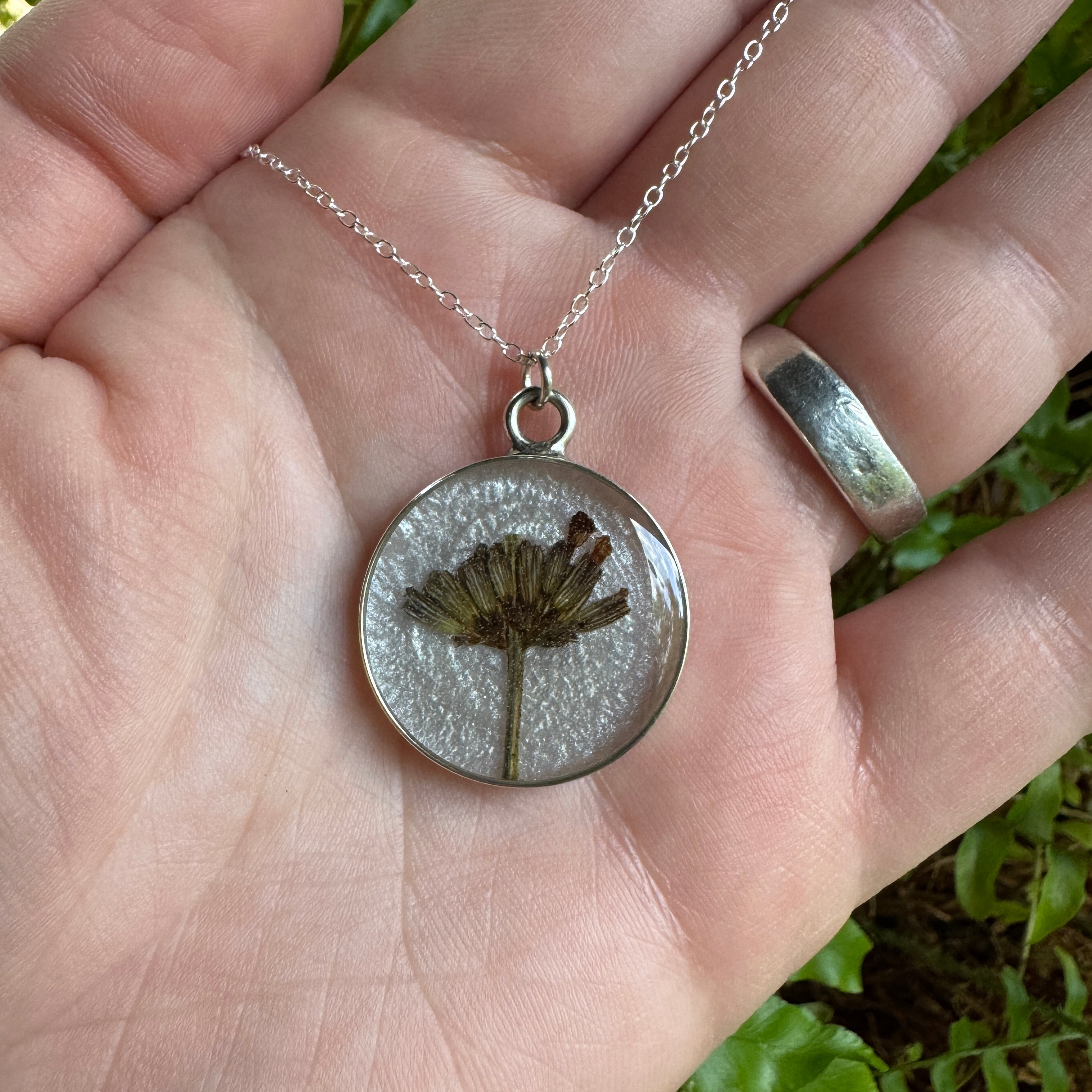 Handmade real lavender circle necklace with preserved lavender in resin, available in Morning Mist white background in sterling silver.