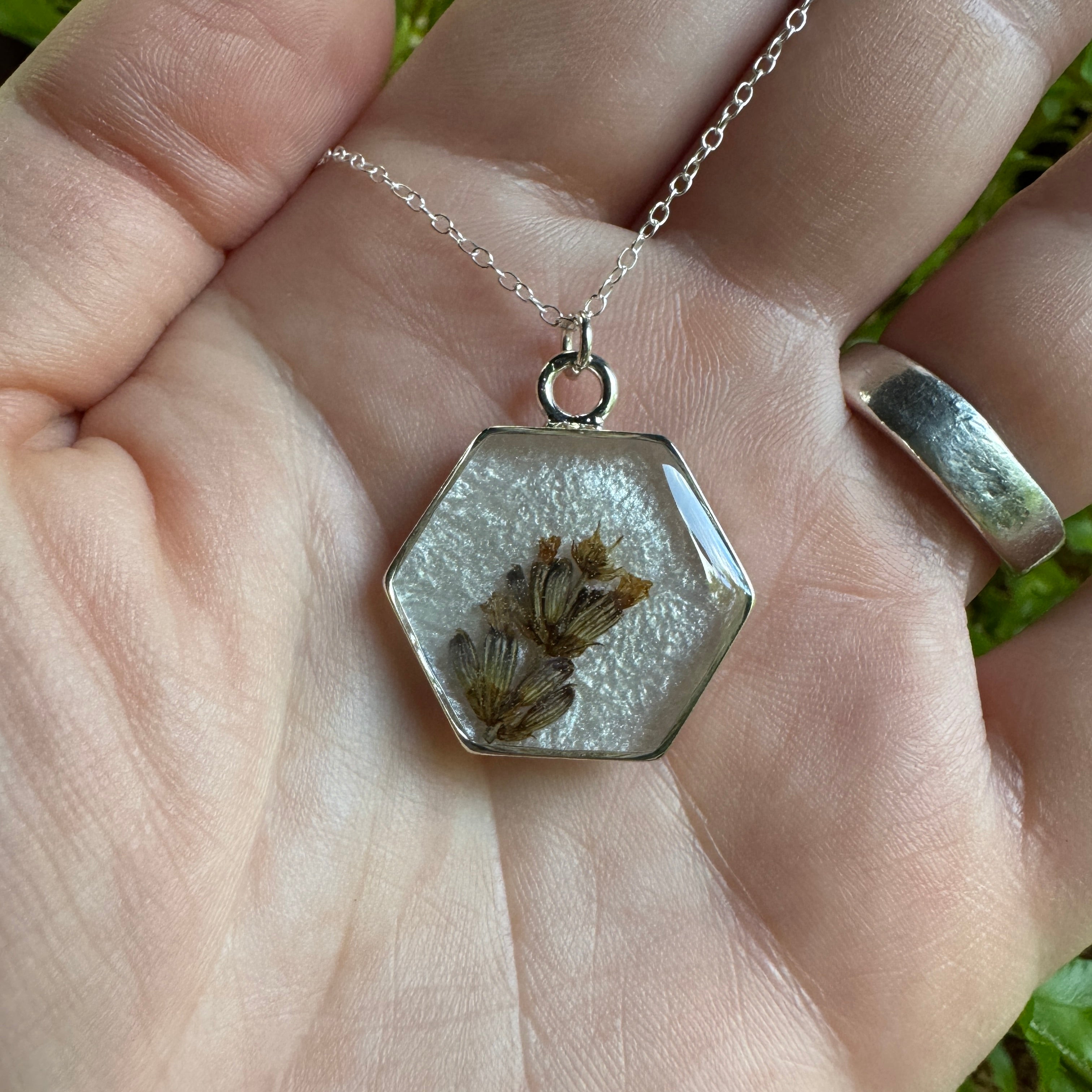 Handmade real lavender hexagon necklace featuring preserved lavender in resin with a Morning Mist white background, available in sterling silver.