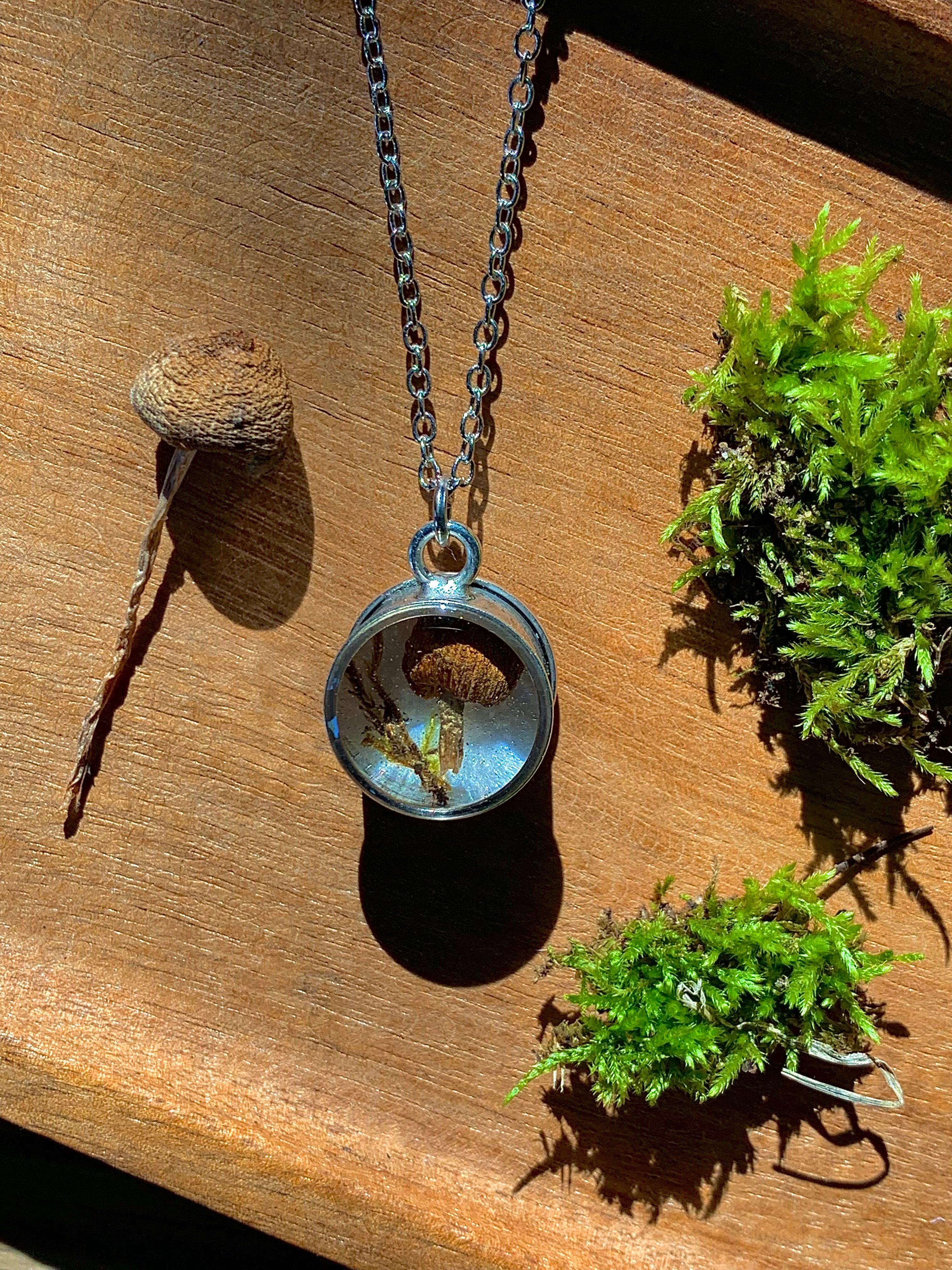 Silver pendant necklace with real moss and mushroom preserved in resin