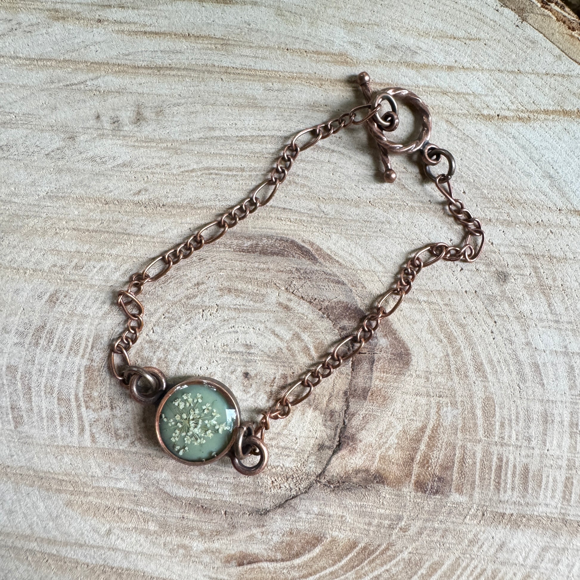 Queen Anne’s Lace flower bracelet preserved in resin with copper bezel