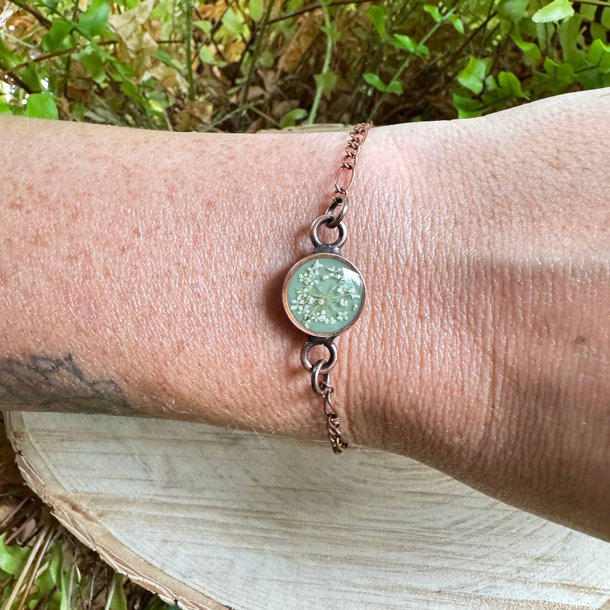Queen Anne’s Lace flower bracelet preserved in resin with copper bezel