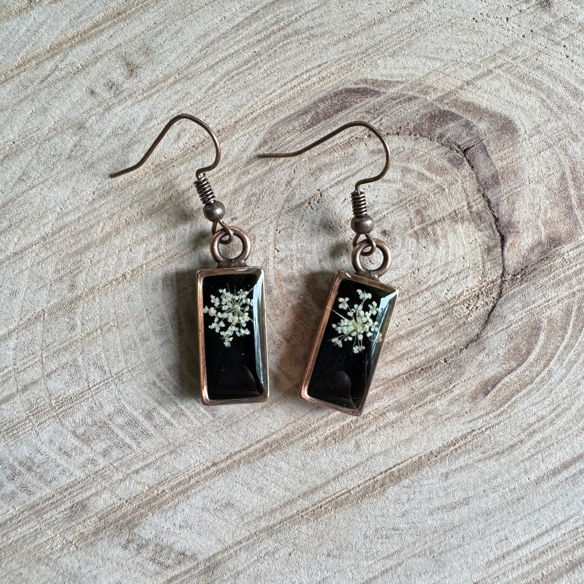 Queen Anne’s Lace flower earrings preserved in resin with copper bezel