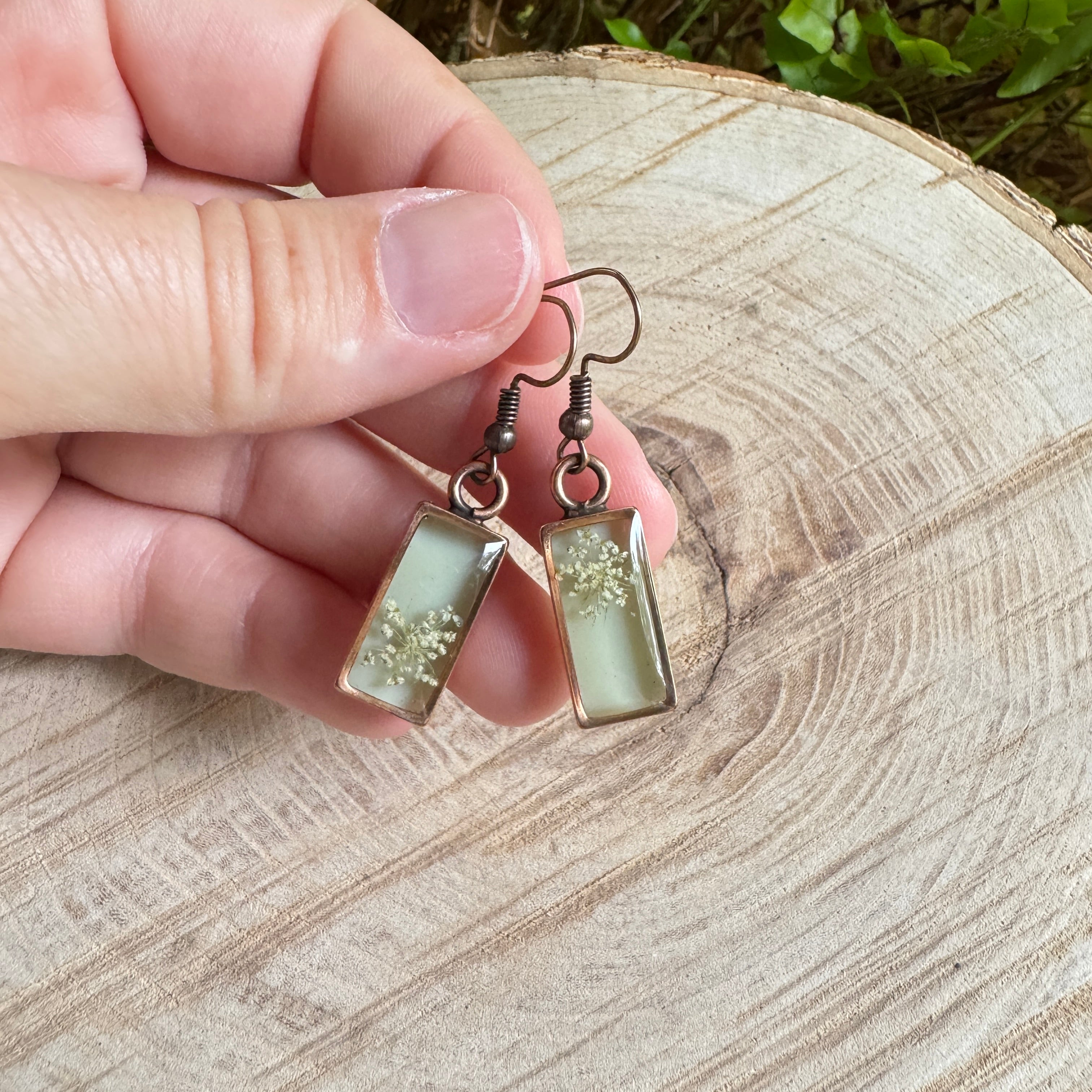 Queen Anne’s Lace flower earrings preserved in resin with copper bezel