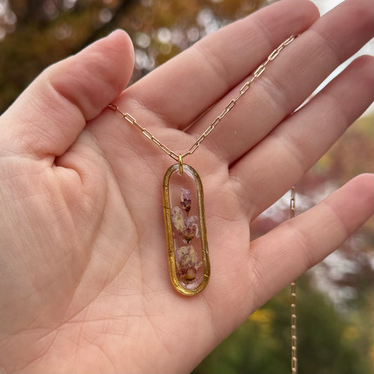Necklace with real Eastern Redbud flower preserved in resin and gold filled bezel