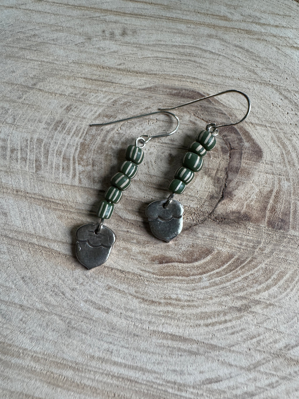 Silver acorn earrings with sculpted detail and forest-inspired design